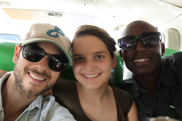 Happy tourists with Isack