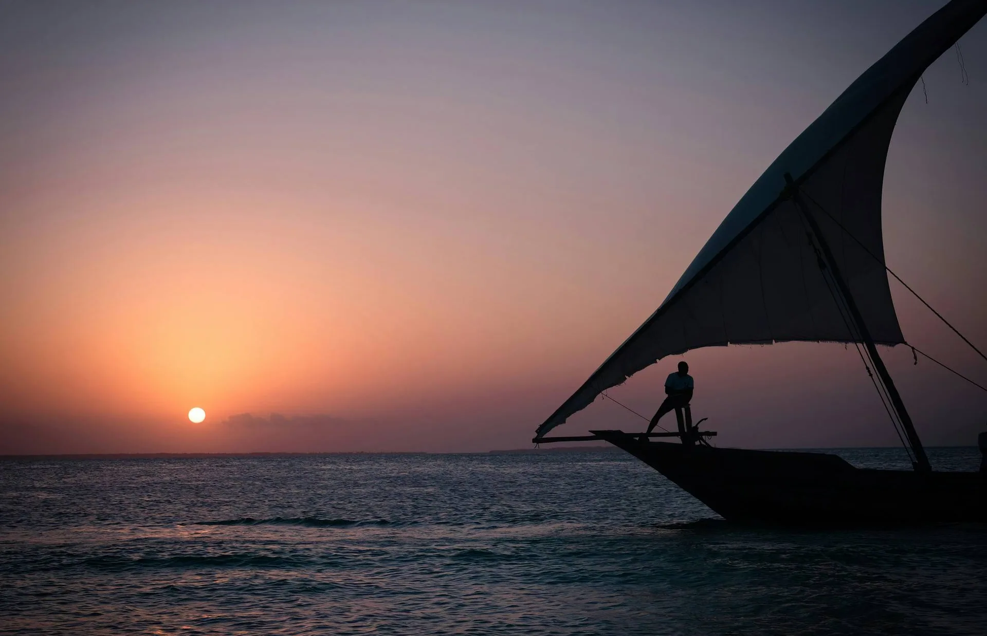 Silhouette of a dhow at sunset off Zanzibar