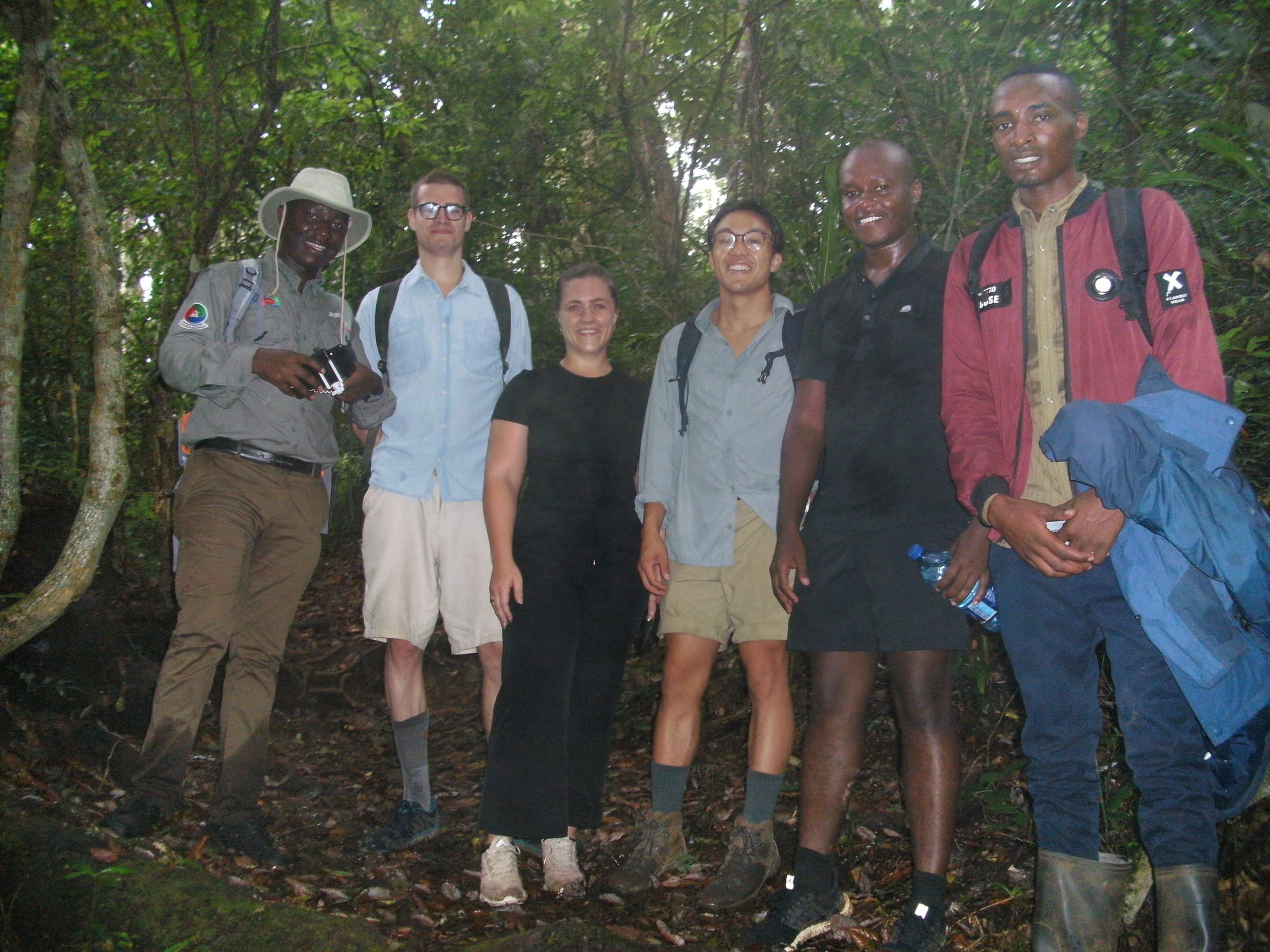 Group gathered on a forest trail