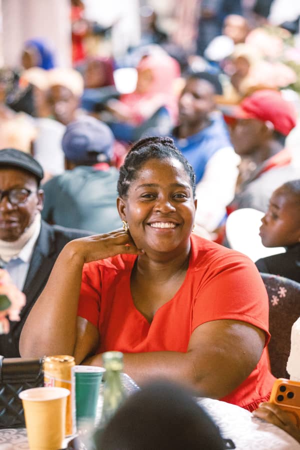 Amina Msangi smiling at a community gathering